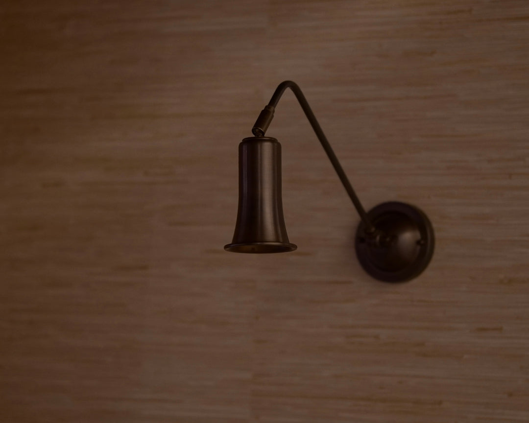 Noir Brass Belle Sconce on textured wall